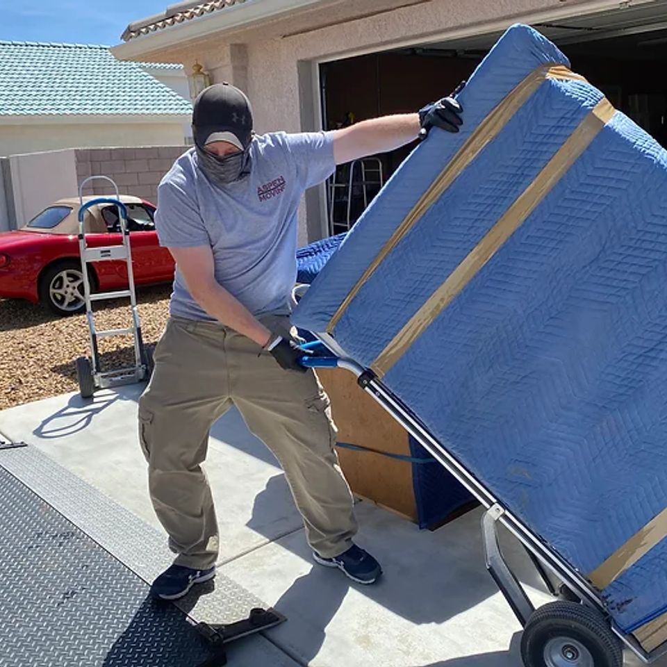 Movers carrying boxes into a home during a local move